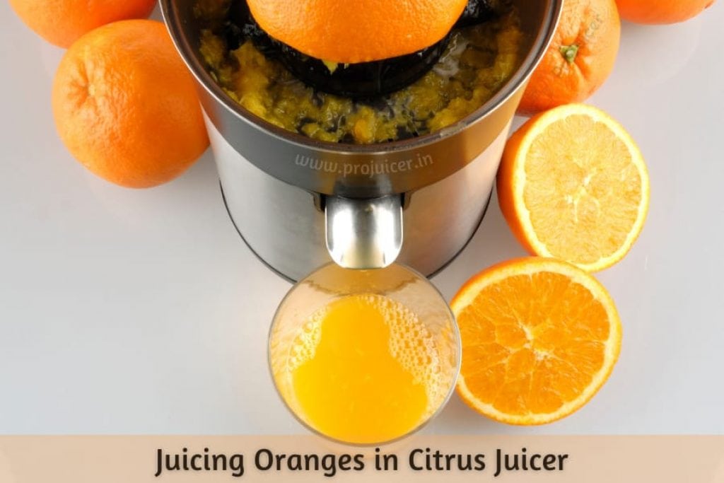 orange juicing in a citrus juicer