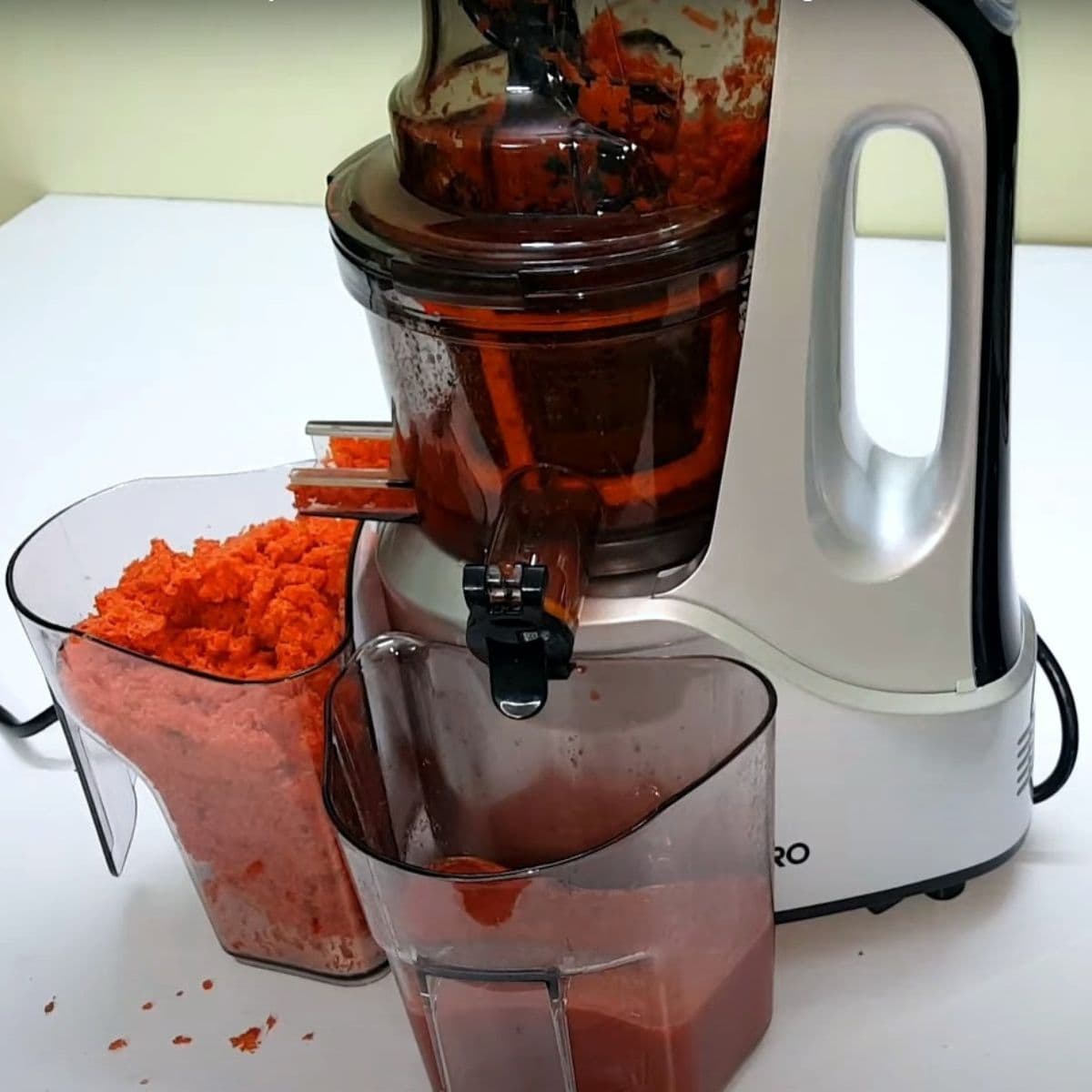 Juicing carrots in Agaro cold press juicer
